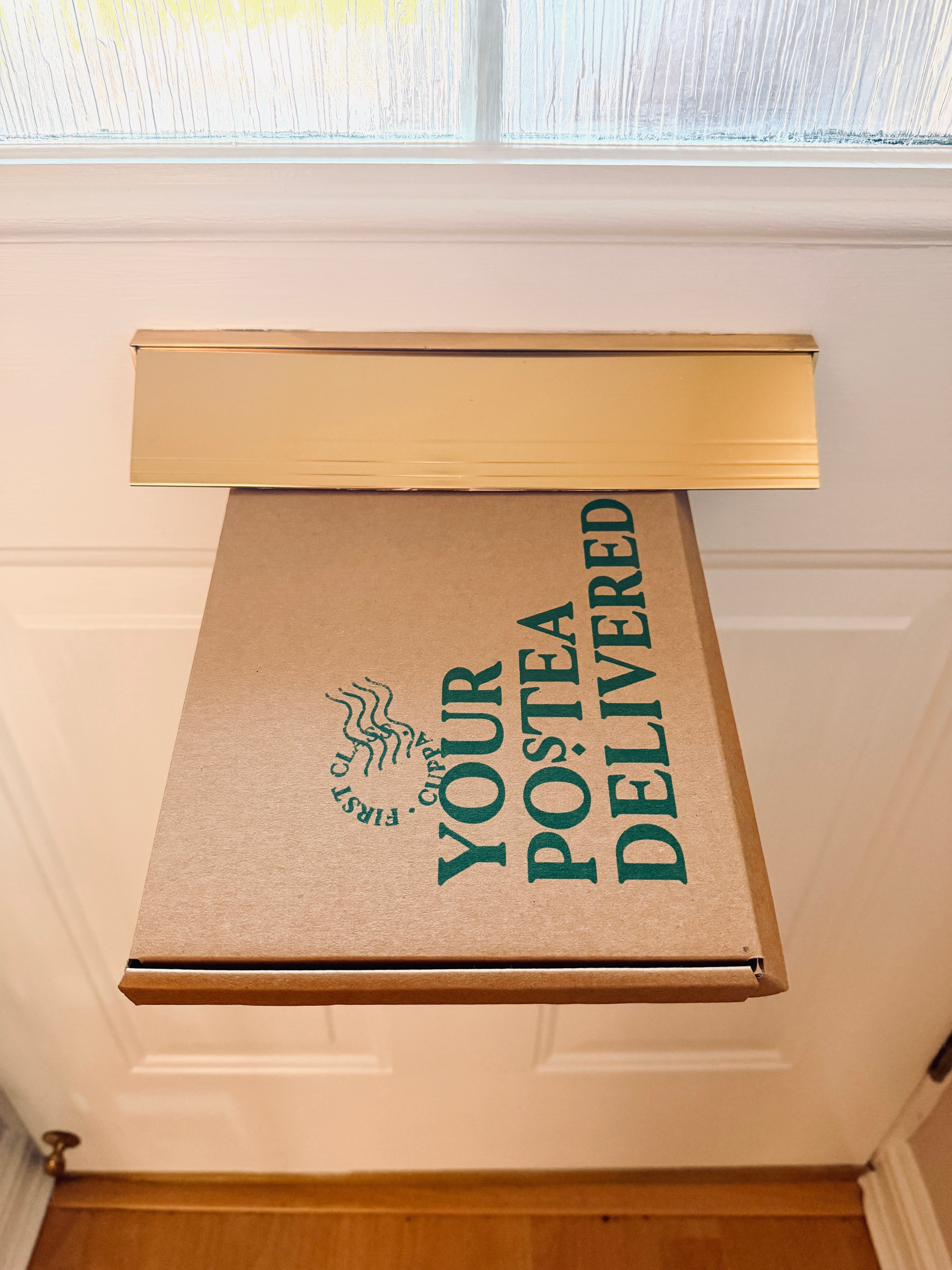 Postea tea box fitting straight through a standard letterbox – "Your Postea Delivered" packaging, no missed deliveries or trips to the post office